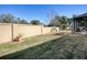 Landscaped backyard with a wall and grass at 307 Batesburg Way, The Villages, FL 32162