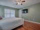 Bright bedroom with a queen bed, wood floors, and ceiling fan at 307 Batesburg Way, The Villages, FL 32162