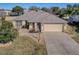 One-story house with attached garage and landscaping at 307 Batesburg Way, The Villages, FL 32162