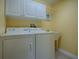 Laundry room with washer, dryer, and cabinets at 307 Batesburg Way, The Villages, FL 32162