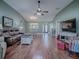 Bright living area featuring hardwood floors and ample natural light at 307 Batesburg Way, The Villages, FL 32162