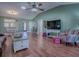 Hardwood floor living room with views into dining and kitchen areas at 307 Batesburg Way, The Villages, FL 32162