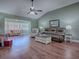 Spacious living room with hardwood floors and vaulted ceilings at 307 Batesburg Way, The Villages, FL 32162