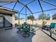 Screened patio with seating area and backyard view at 307 Batesburg Way, The Villages, FL 32162