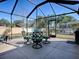 Relaxing screened patio with table and chairs at 307 Batesburg Way, The Villages, FL 32162