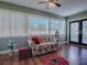 Bright sunroom featuring a floral couch and French doors at 307 Batesburg Way, The Villages, FL 32162