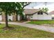 White home with stone accents and a large grassy yard at 31 Sand Lake Pl, Eustis, FL 32726