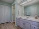 Bathroom boasts double sinks, light lavender cabinets, and a shower at 32622 Oak Park Dr, Leesburg, FL 34748