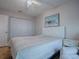 Bedroom featuring a queen bed, ceiling fan, and closet at 32622 Oak Park Dr, Leesburg, FL 34748