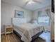 Well-lit bedroom with a queen bed and light walls at 32622 Oak Park Dr, Leesburg, FL 34748