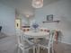 Dining area with white table and chairs, near a bathroom and entryway at 32622 Oak Park Dr, Leesburg, FL 34748