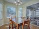 Cozy dining area with table and chairs and access to screened porch at 32622 Oak Park Dr, Leesburg, FL 34748