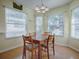 Bright dining area with wood table and chairs, near sunroom at 32622 Oak Park Dr, Leesburg, FL 34748