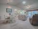 Casual dining area with white table and chairs, and a view of the kitchen at 32622 Oak Park Dr, Leesburg, FL 34748