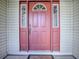 Eye-catching coral front door with sidelights and etched glass at 32622 Oak Park Dr, Leesburg, FL 34748