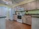 Well-equipped kitchen with white appliances and light wood cabinets at 32622 Oak Park Dr, Leesburg, FL 34748