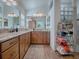 Elegant bathroom with dual sinks, granite countertops, and a glass-block shower at 3281 Bell Ter, The Villages, FL 32163