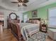 Spacious bedroom with a wooden sleigh bed and ample natural light at 3281 Bell Ter, The Villages, FL 32163