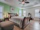 Main bedroom with wood sleigh bed, and decorative artwork at 3281 Bell Ter, The Villages, FL 32163