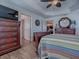 Well-lit bedroom with wood floors and access to other rooms at 3281 Bell Ter, The Villages, FL 32163