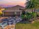 Home exterior at sunset with palm trees at 3281 Bell Ter, The Villages, FL 32163