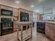 Modern kitchen with black appliances and wood cabinets at 3281 Bell Ter, The Villages, FL 32163