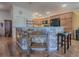 Kitchen island with granite countertop and breakfast bar at 3281 Bell Ter, The Villages, FL 32163