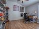 Home office with wood floors, desk, and display shelving at 3281 Bell Ter, The Villages, FL 32163