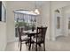 Bright breakfast nook with a round table and four chairs near a window at 3538 Mistletoe Ct, The Villages, FL 32163