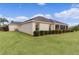 Side view of a single-story house with a screened porch and neatly trimmed shrubs at 3538 Mistletoe Ct, The Villages, FL 32163