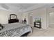 Spacious main bedroom with king-size bed and access to the ensuite bathroom at 3538 Mistletoe Ct, The Villages, FL 32163