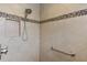 Large walk-in shower with tiled walls and grab bar at 3538 Mistletoe Ct, The Villages, FL 32163