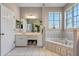 Bathroom boasts a corner bathtub and double vanity with updated countertops at 3546 Tropical Seas Loop, Tavares, FL 32778