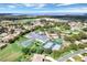 Aerial view of community with lake, tennis courts, and pool at 3546 Tropical Seas Loop, Tavares, FL 32778