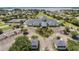 Aerial view of community clubhouse, tennis courts, and lake at 3546 Tropical Seas Loop, Tavares, FL 32778