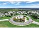 Aerial view of community entrance with lighthouse-themed rotunda at 3546 Tropical Seas Loop, Tavares, FL 32778