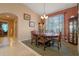 Formal dining room with a large table, six chairs, and an elegant chandelier at 3546 Tropical Seas Loop, Tavares, FL 32778