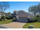 House with a two-car garage and nicely landscaped yard at 3546 Tropical Seas Loop, Tavares, FL 32778