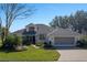 House with a two-car garage and nicely landscaped yard at 3546 Tropical Seas Loop, Tavares, FL 32778