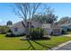 One-story home with a two car garage and manicured lawn at 3546 Tropical Seas Loop, Tavares, FL 32778