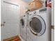 Convenient laundry room with washer, dryer, and extra storage shelves at 3546 Tropical Seas Loop, Tavares, FL 32778