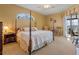 Large main bedroom with a four-poster bed and access to the lanai at 3546 Tropical Seas Loop, Tavares, FL 32778