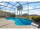 Inviting screened-in pool with a large backyard view at 3546 Tropical Seas Loop, Tavares, FL 32778