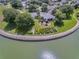 Aerial view of waterfront home with landscaping and Royal Harbor sign at 3546 Tropical Seas Loop, Tavares, FL 32778