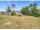 Spacious backyard with various outbuildings and landscaping at 3566 Seminole St, Gotha, FL 34734