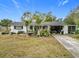 Ranch-style home with carport and mature landscaping at 3566 Seminole St, Gotha, FL 34734