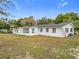 White house exterior with large windows and mature trees at 3566 Seminole St, Gotha, FL 34734