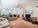 Living room with coastal decor, featuring beige couches and pink carpet at 3566 Seminole St, Gotha, FL 34734