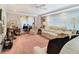 Living room with view into dining area, featuring beige couches and pink carpet at 3566 Seminole St, Gotha, FL 34734