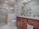 Bathroom boasts granite vanity, tiled shower, and modern fixtures at 3590 Ithaca Ter, The Villages, FL 32163